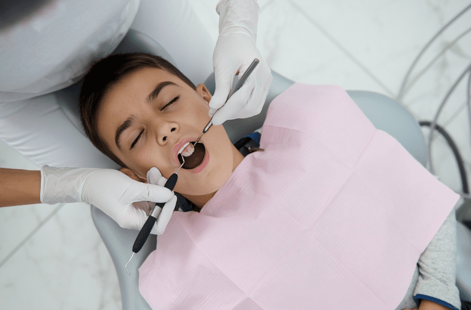 Child receiving dental check-up with tools. | Lake Periodontics of Saratoga Springs, New York