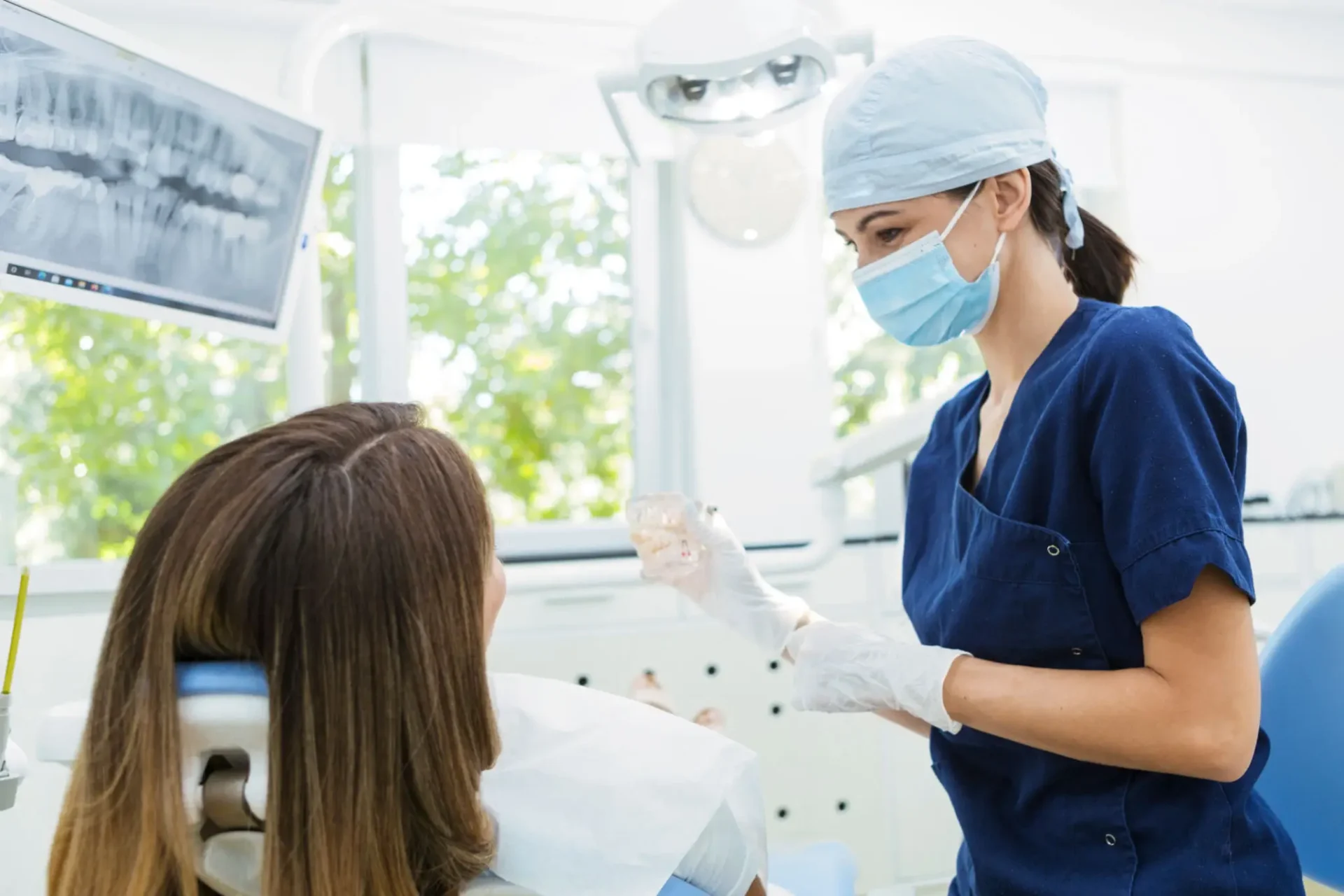 Dentist explaining dental care to a patient in a clinic.