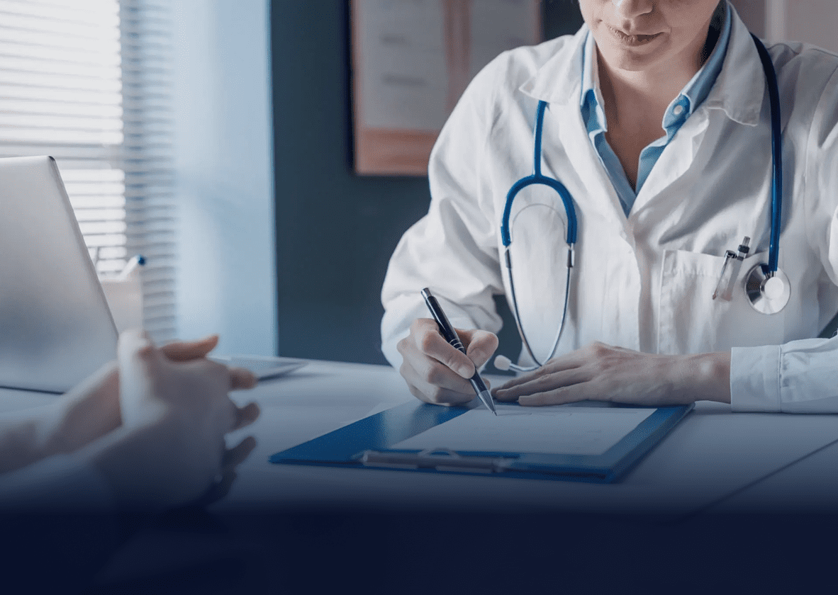 Doctor consulting a patient and taking notes during a medical appointment.