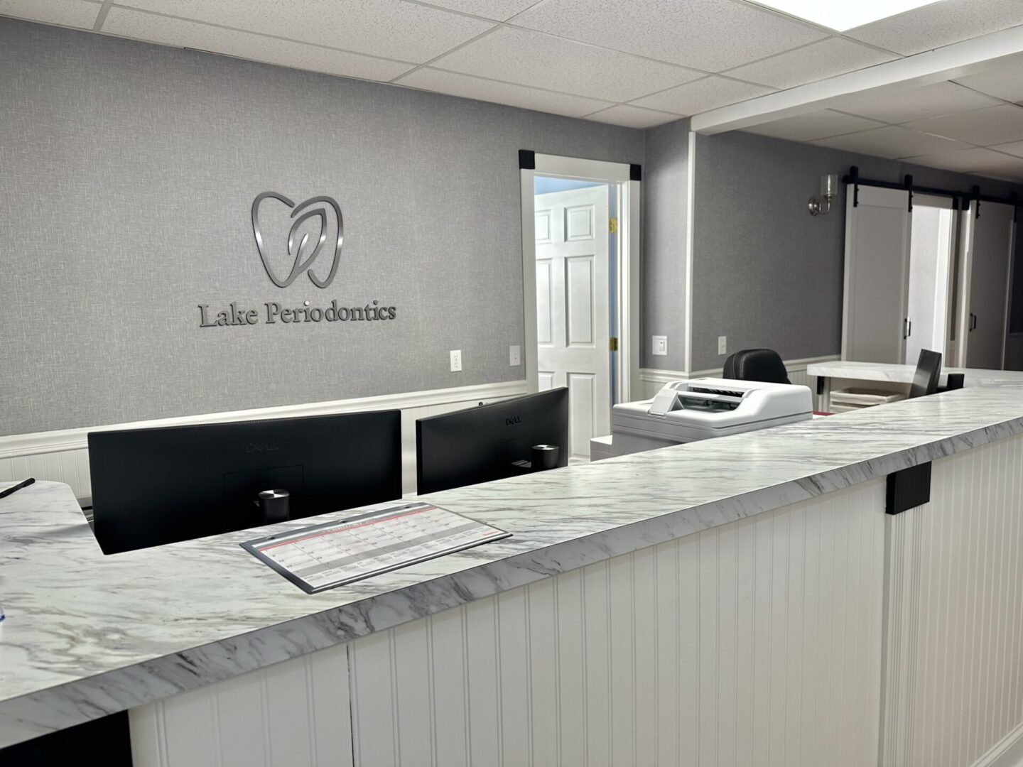 Modern dental clinic reception area with a clean marble counter.